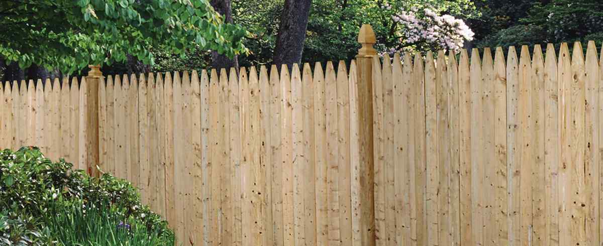 Cedar dog-ear picket privacy fence with galvanized ring-shank fastening in Belton, MO — RKC Wood Care Pros