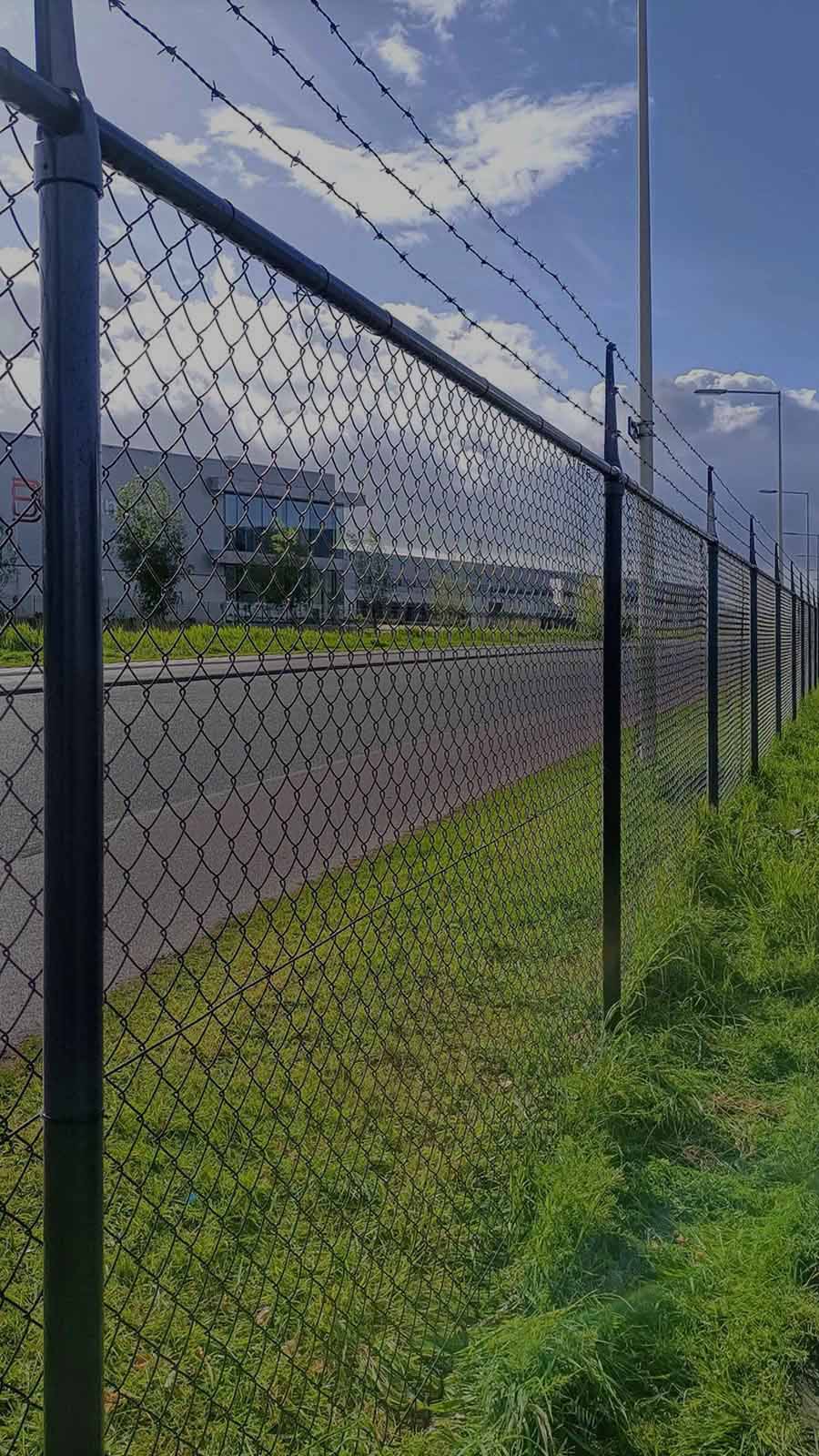 Galvanized chain link perimeter fence with knuckle-twist selvage in Independence, MO — RKC Wood Care Pros
