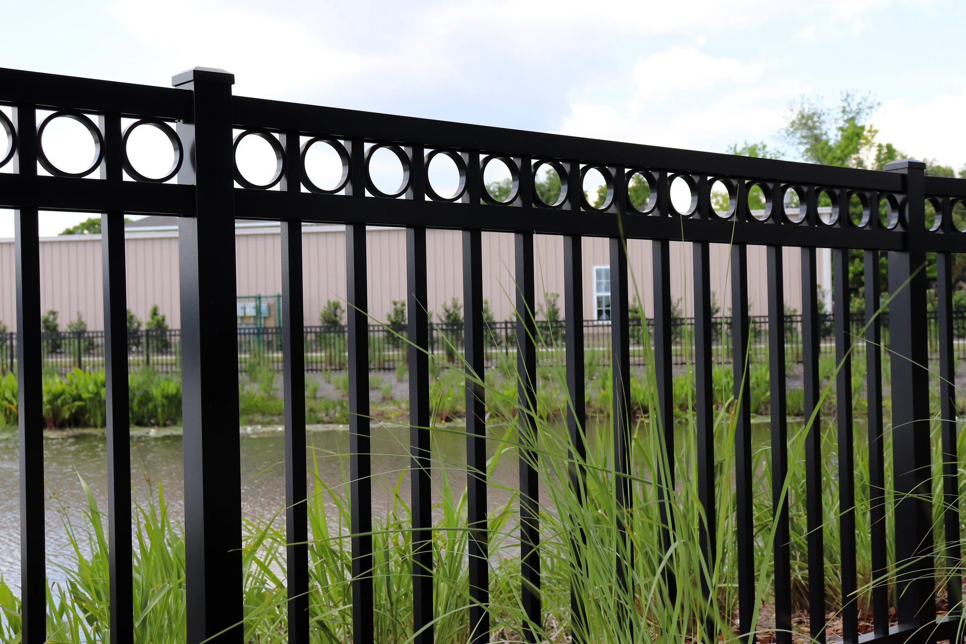 Powder-coated aluminum fence panels showing no rust after sprinkler contact, installed by RKC Wood Care Pros