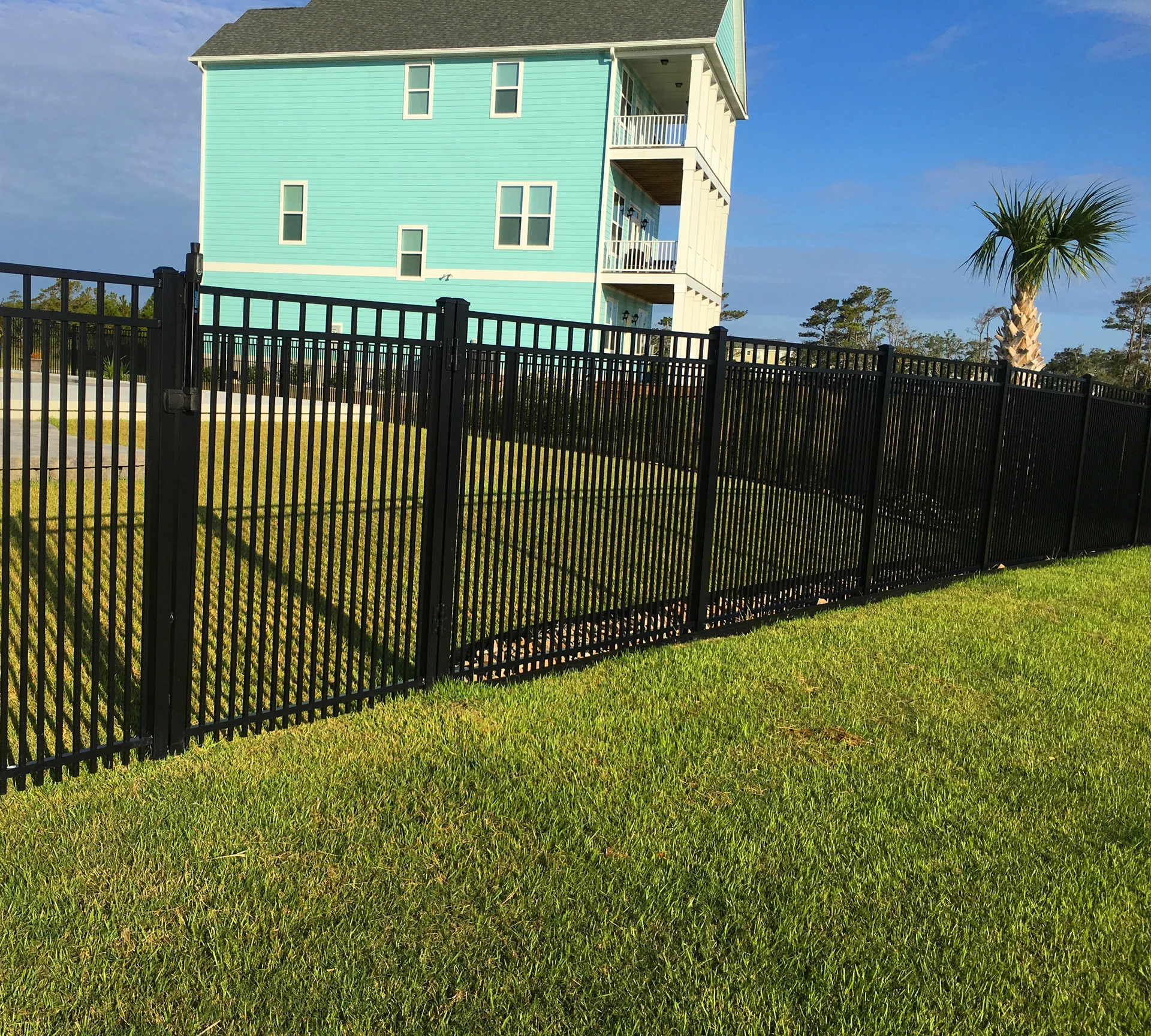 Black aluminum fence install showing AAMA 2604 powder-coat integrity and 36-inch post depth by RKC Wood Care Pros