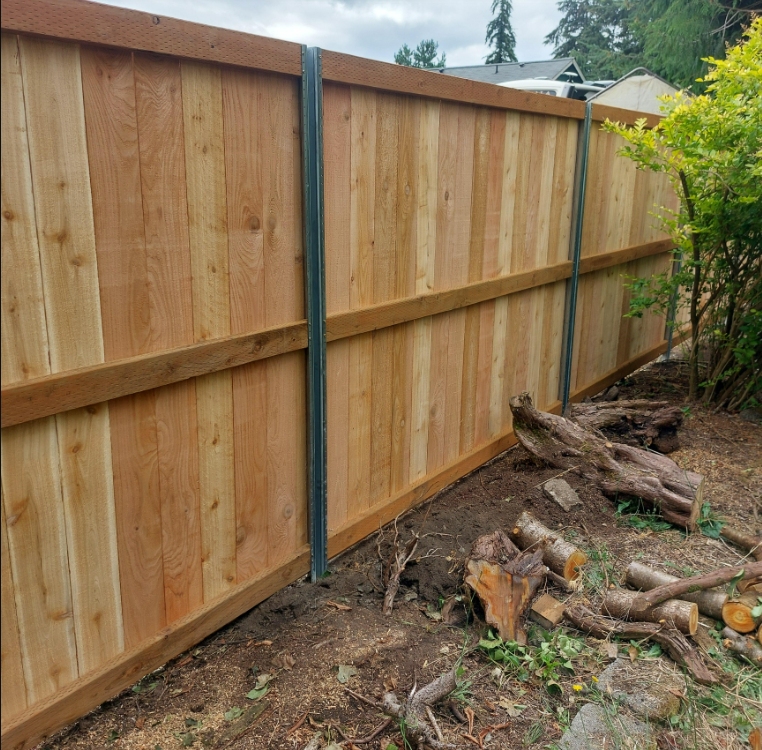 Western Red Cedar privacy fence set 36 inches deep in concrete in Smithville, MO — RKC Wood Care Pros