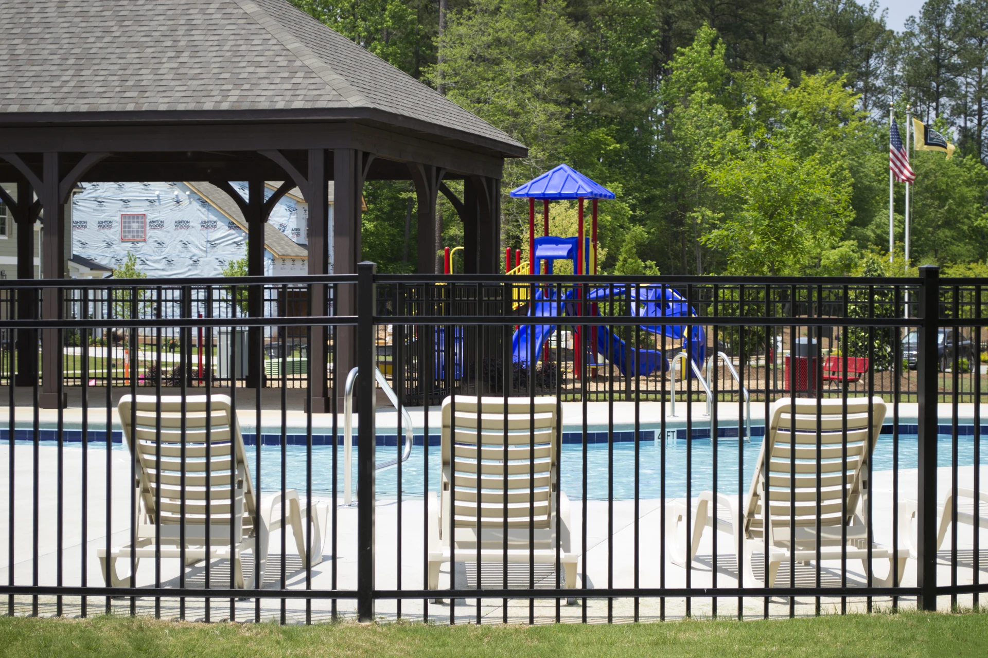 Pool-code aluminum fence blending into the landscape around an Olathe, KS backyard pool