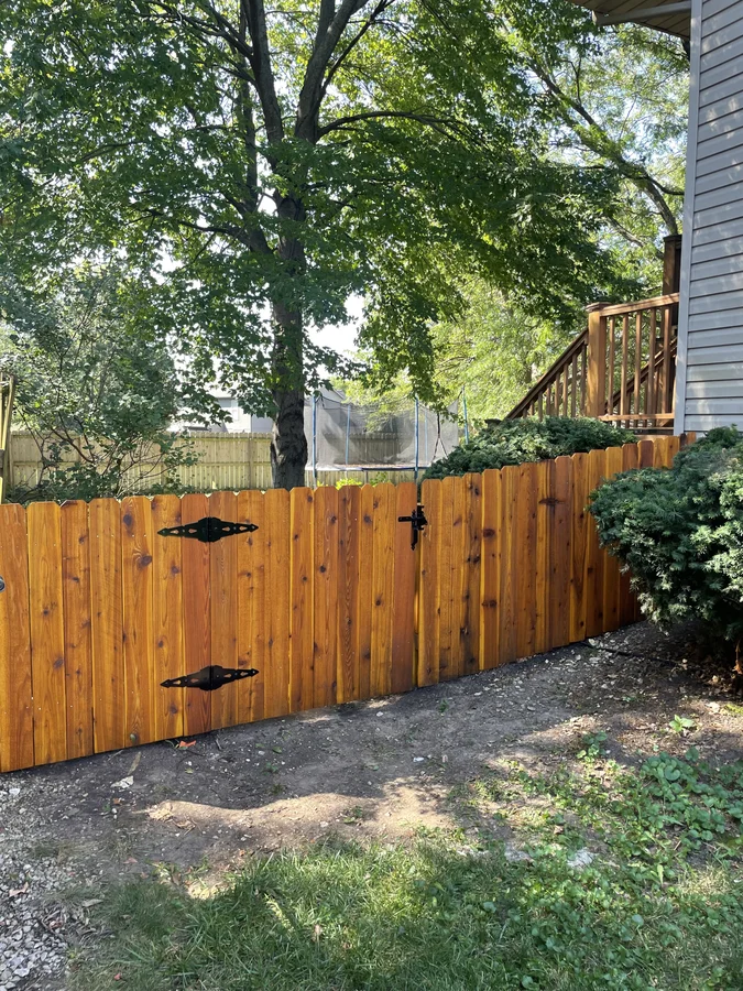Cedar privacy fence on sloped lot in Bonner Springs, KS by RKC Wood Care Pros