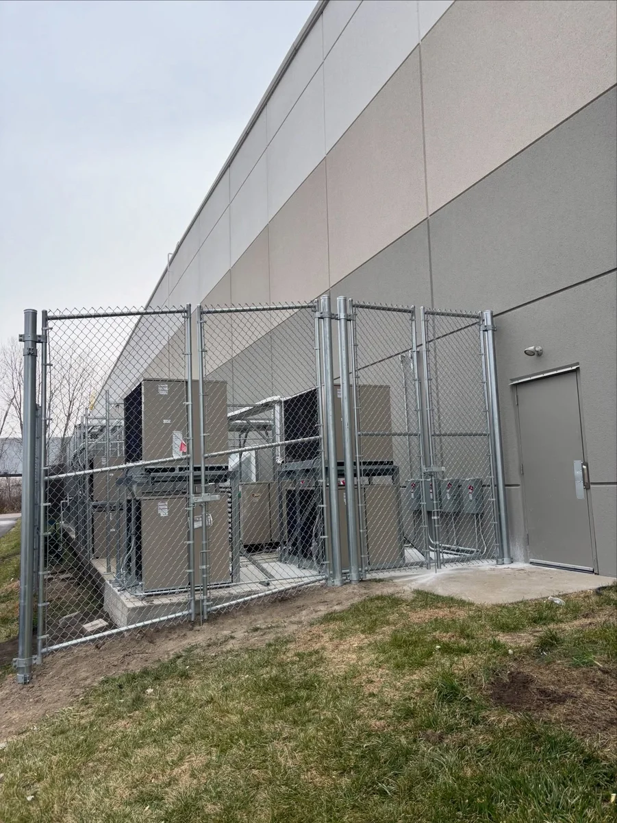 Galvanized chain link fence enclosing an HVAC unit in Kansas City — RKC Wood Care Pros