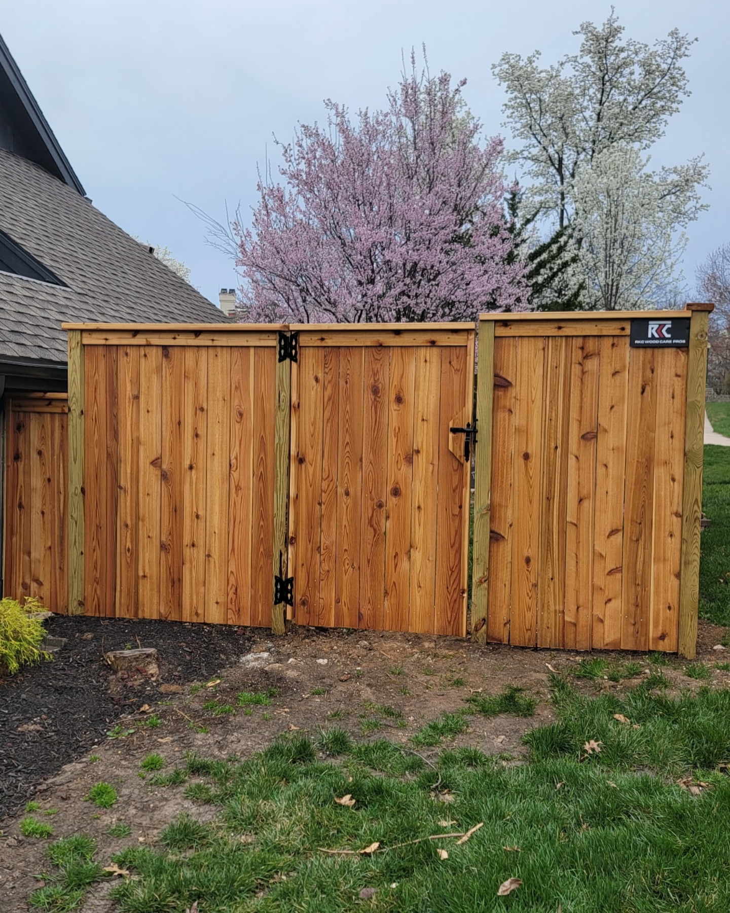 Cedar double-drive gate with heavy-duty strap hinges and diagonal cross-brace in Kansas City — RKC Wood Care Pros