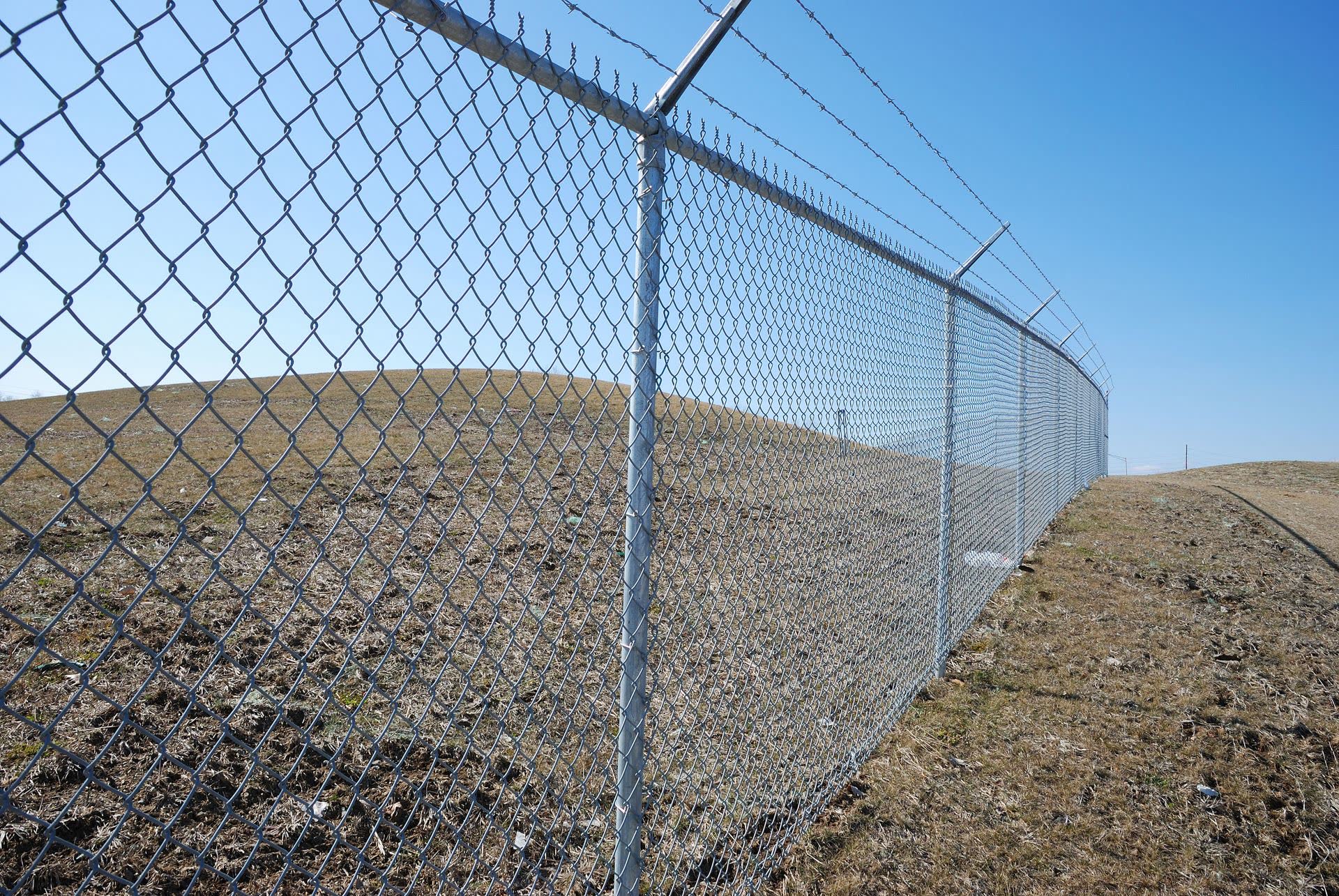 RKC Wood Care Pros installing galvanized chain link with 36-inch post depth and truss-rod bracing in Kansas City