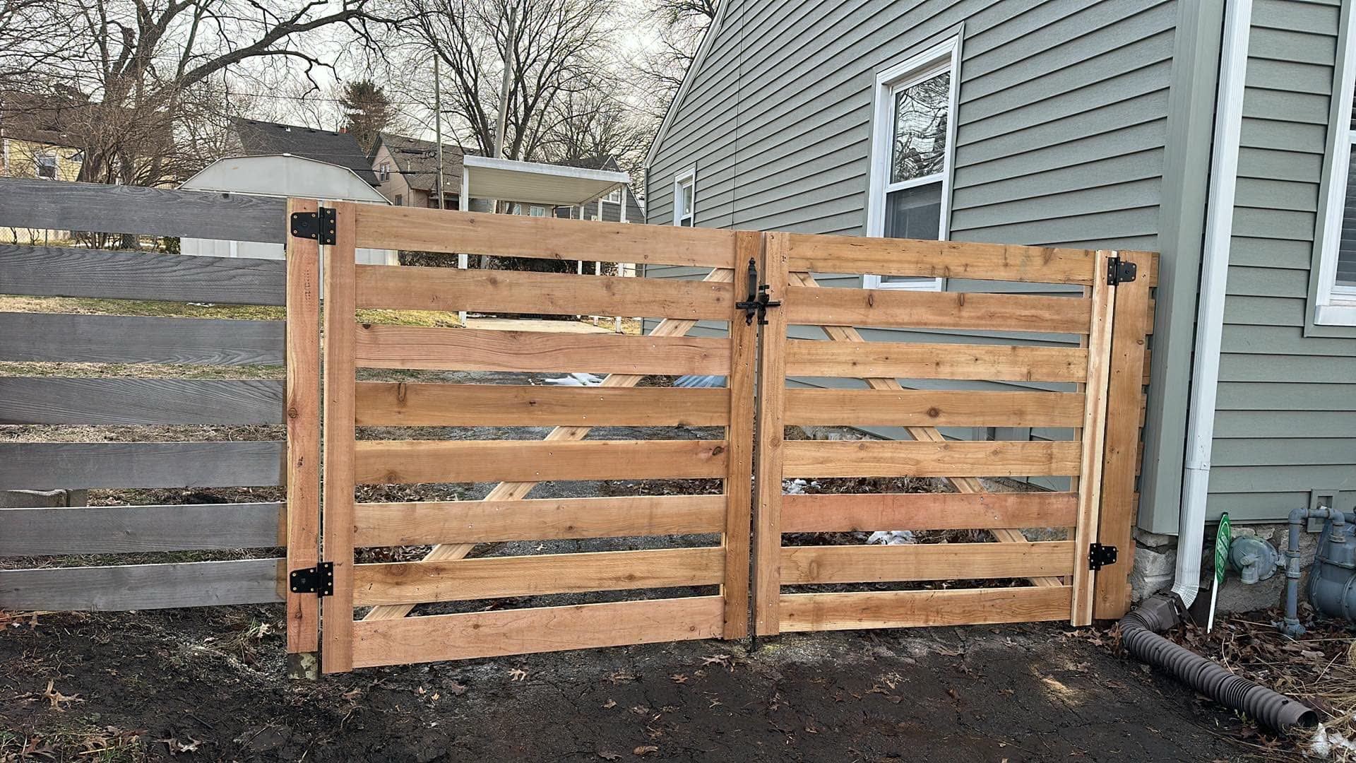 Pool-code aluminum fence with self-closing gate in Kansas City by RKC Wood Care Pros