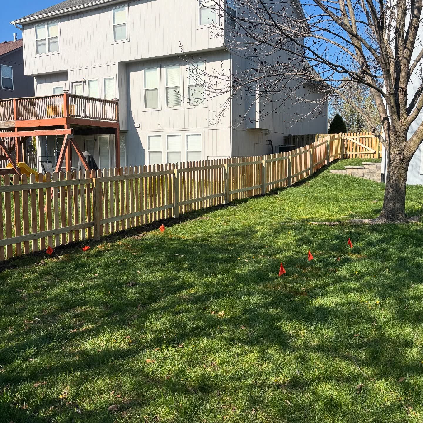 Kansas City backyard patio fully screened by a 6-foot cedar privacy fence installed by RKC Wood Care Pros
