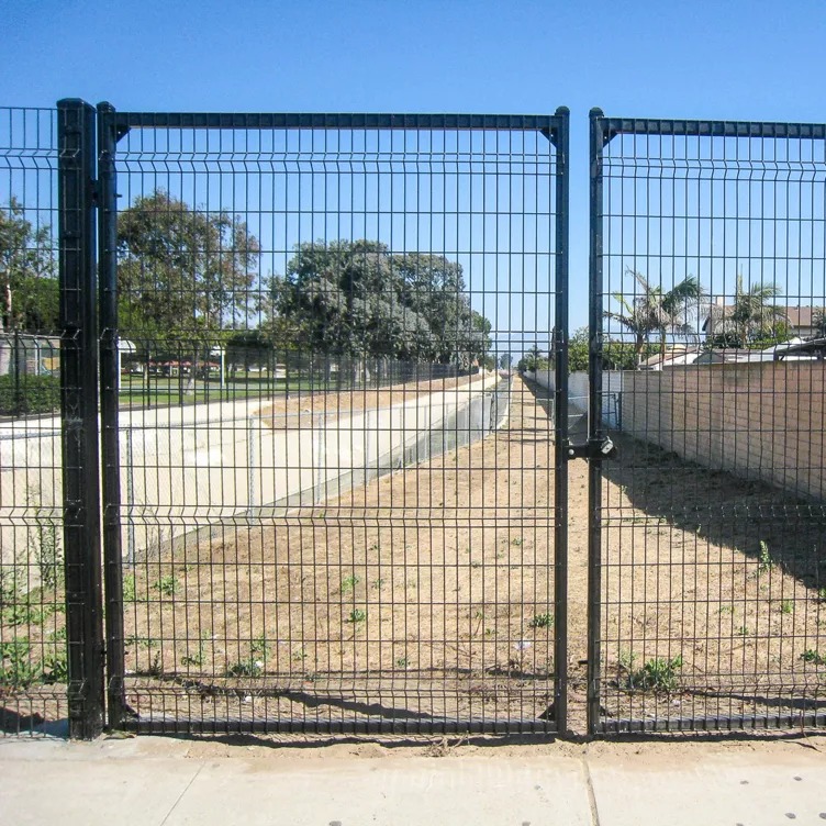 Welded wire mesh utility gate at a Kansas City perimeter fence line — RKC Wood Care Pros