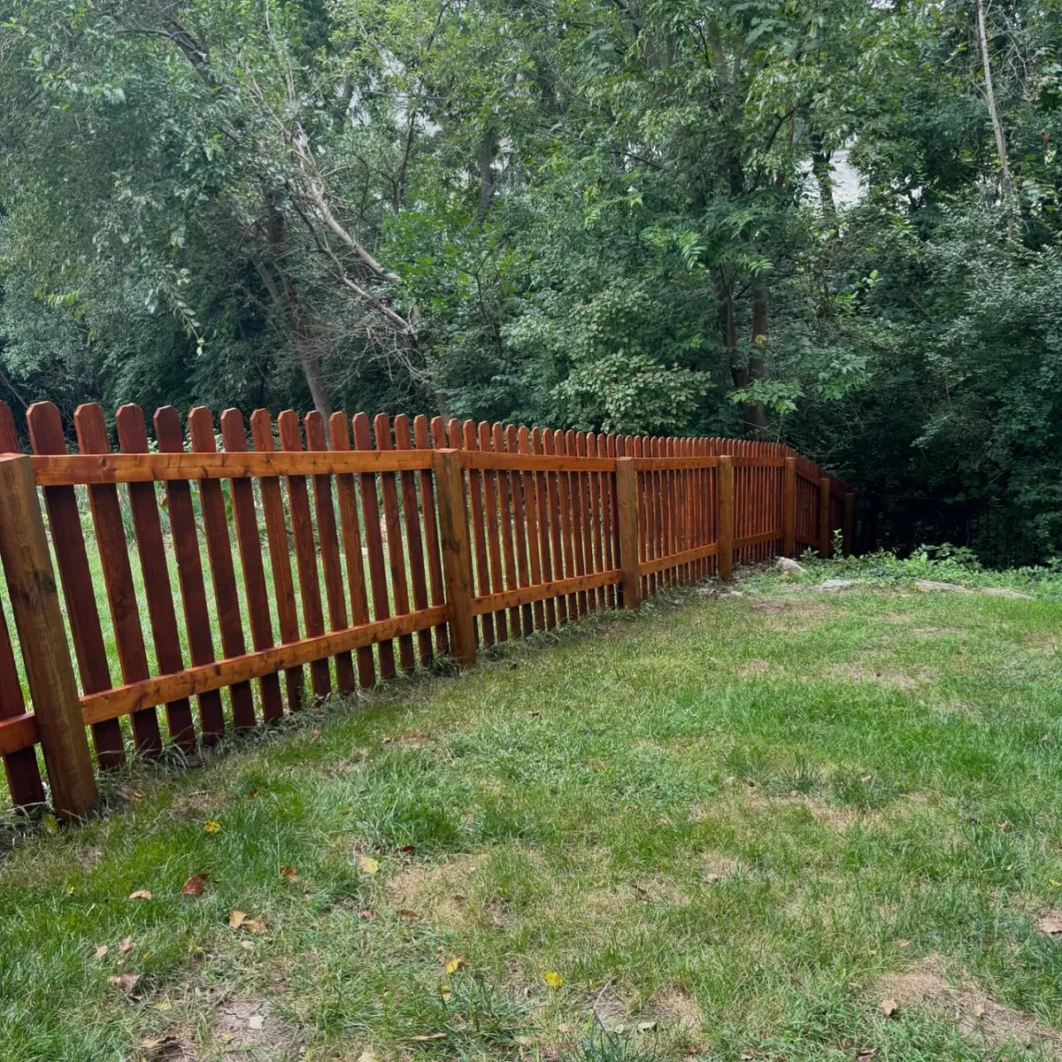 Cedar fence boards with rich stain color and post detail in Belton, MO