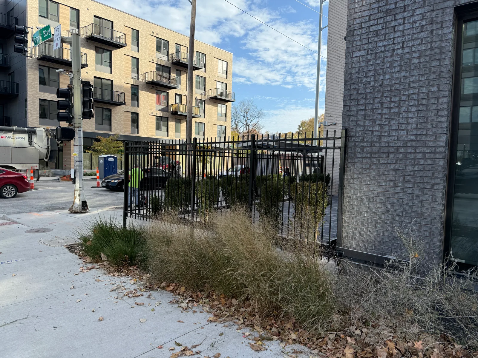Black ornamental iron fence along a commercial apartment building in Kansas City, MO — street view