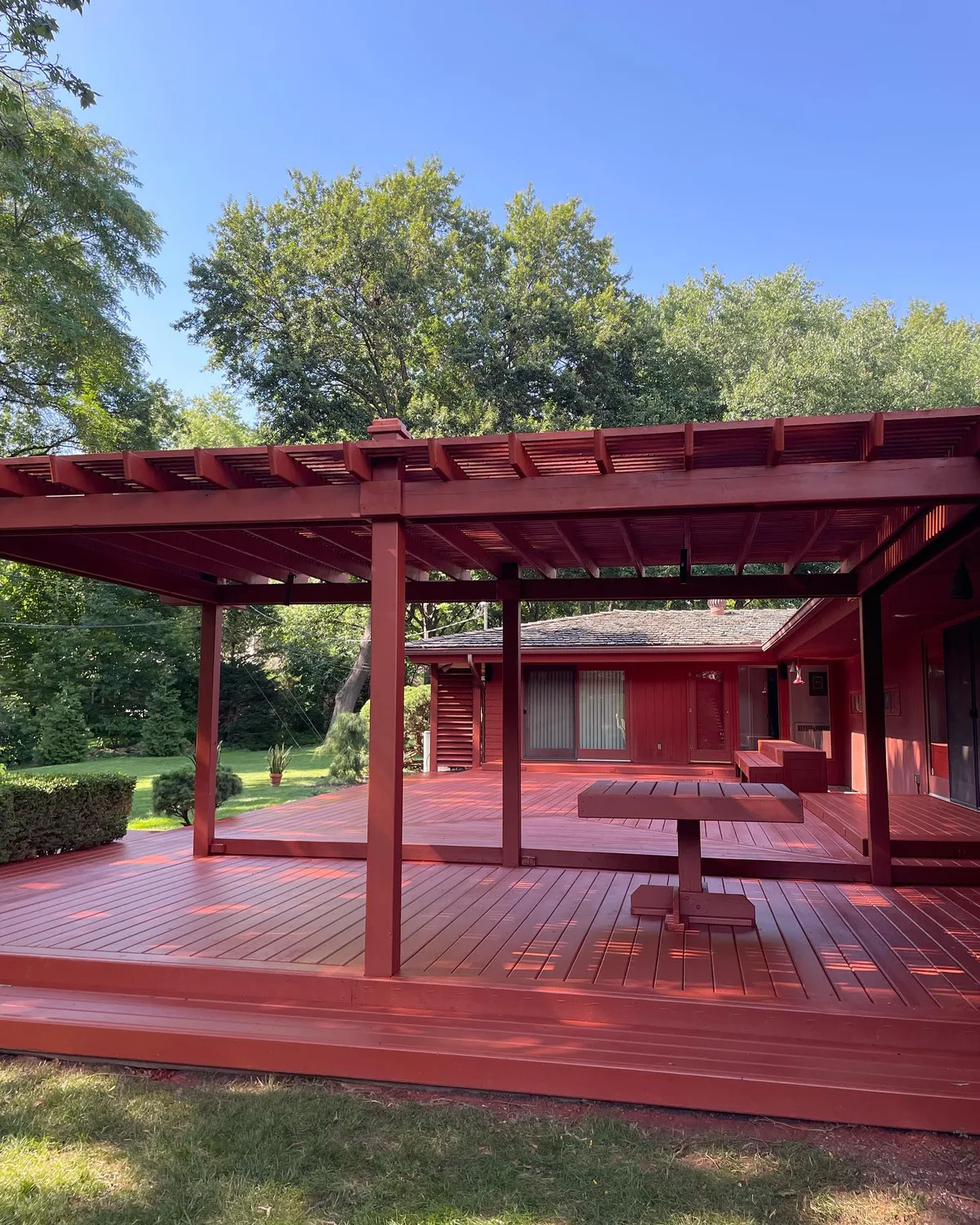 Deck surface and pergola overhead beams stained cedar brown in Liberty, MO