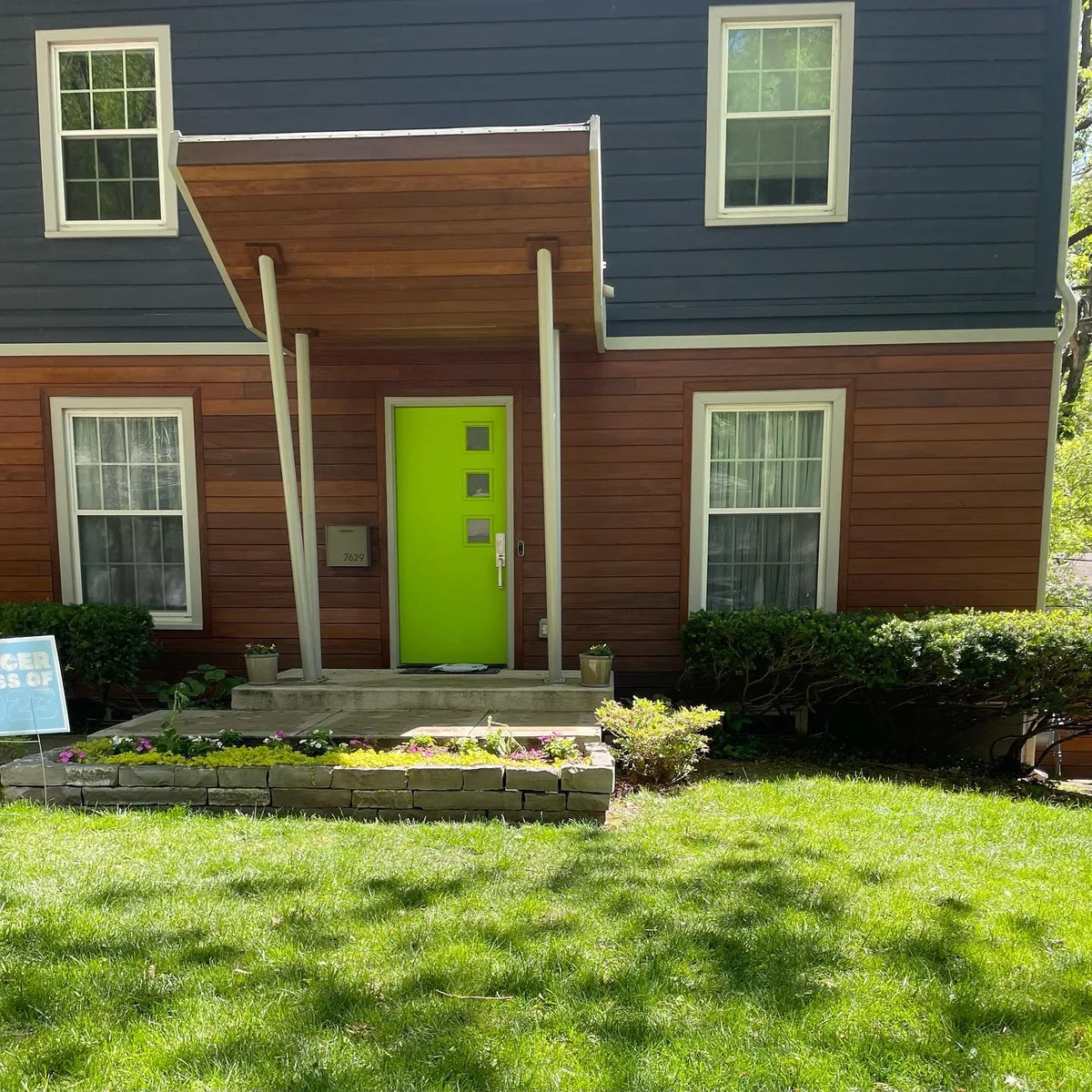 Cedar siding on side elevation with freshly stained finish at Kansas City, MO property